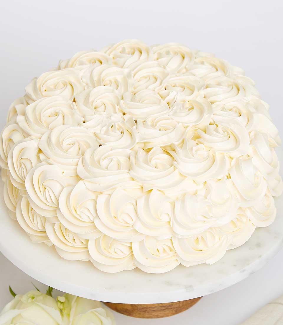 Creamy Indulgence white buttercream layer cake with rosette frosting design for birthday celebrations