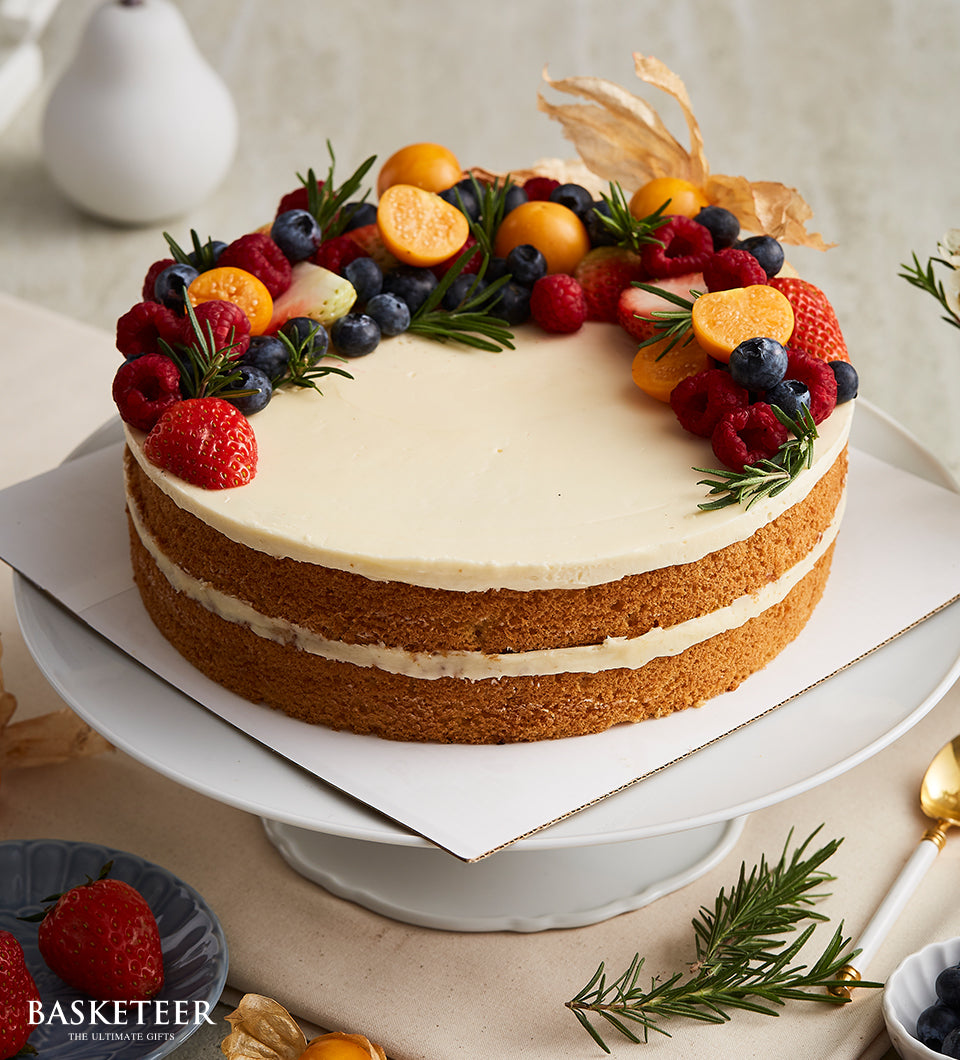 Mix berries vanilla butter cake with fresh strawberries, blueberries, and raspberries on white frosting, artisan celebration