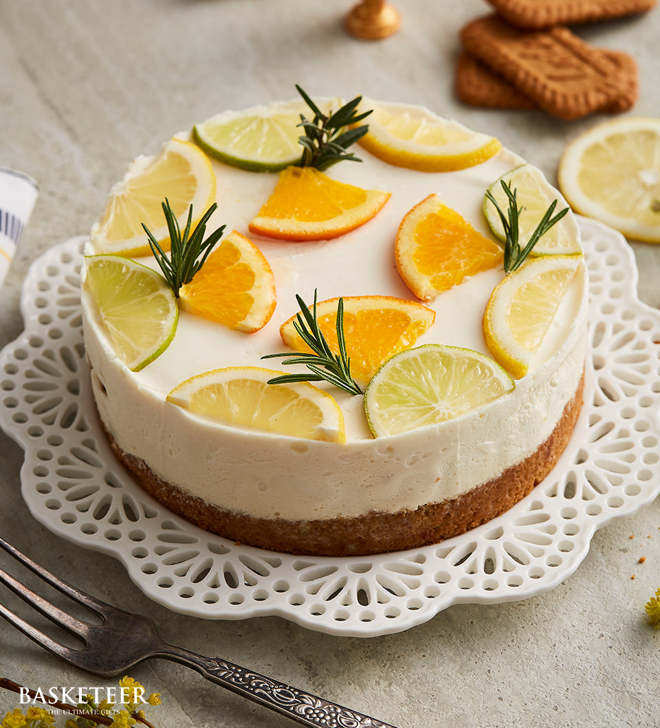 Lemon curd cheesecake with citrus and rosemary garnish on decorative plate