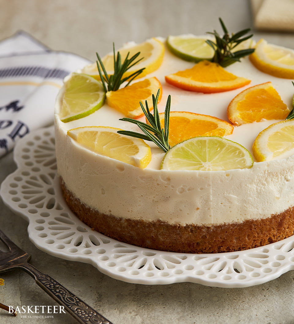Lemon curd cheesecake with citrus slices and rosemary on ceramic stand, birthday cake gift