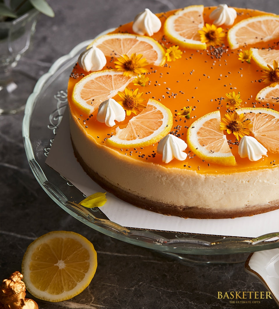 Charlotte Bakery Passion Fruit Cheesecake. Citrus slices, meringue kisses, and edible flowers decorate this artisan cake. Order custom cake Bangkok.