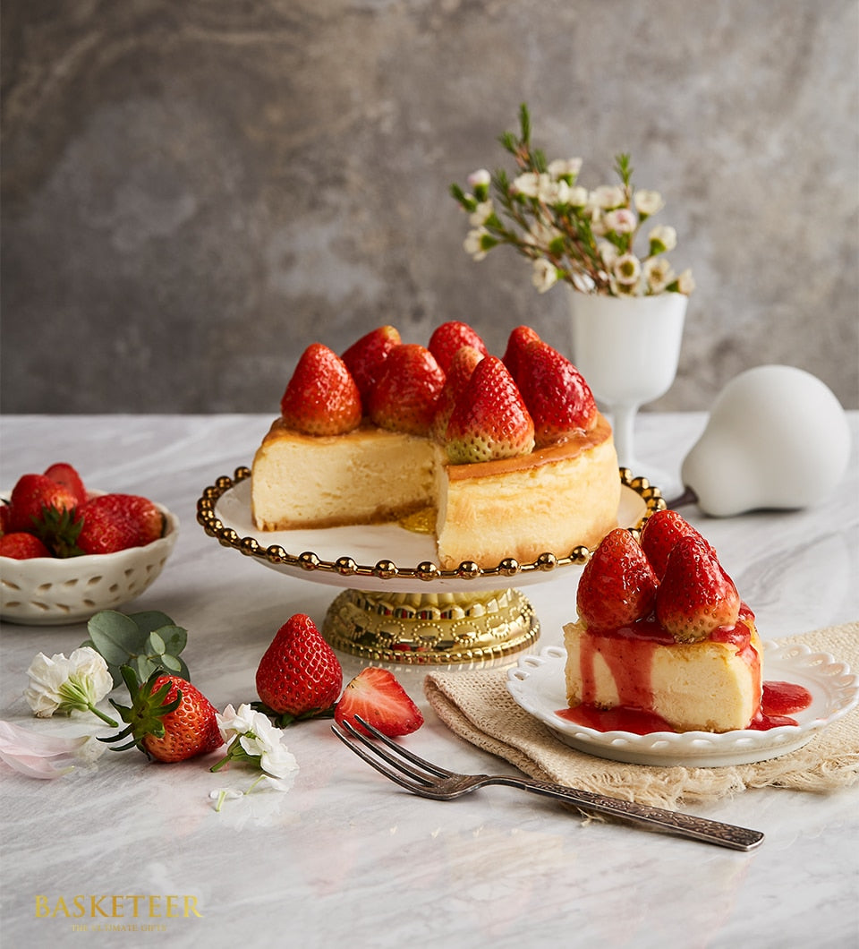 New York strawberry cheesecake with fresh berries and gold cake stand, artisan birthday gift