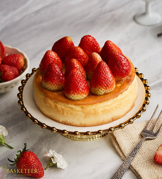 New York strawberry cheesecake with fresh berries on gold-rimmed cake stand, creamy classic birthday dessert