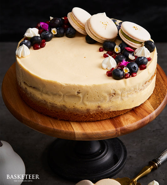 Berry Bliss vanilla cheesecake with macaron toppers and fresh blueberries, artisan birthday cake by Charlotte Bakery