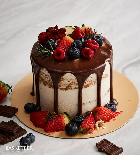 Mini chocolate drip cake with fresh berries and cream, quarter-pound artisan celebration cake
