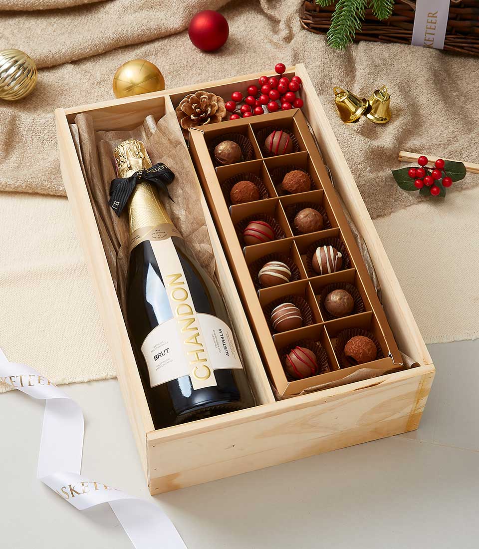 Luxury wooden gift box with Chandon Brut sparkling wine and artisan chocolates, festive presentation