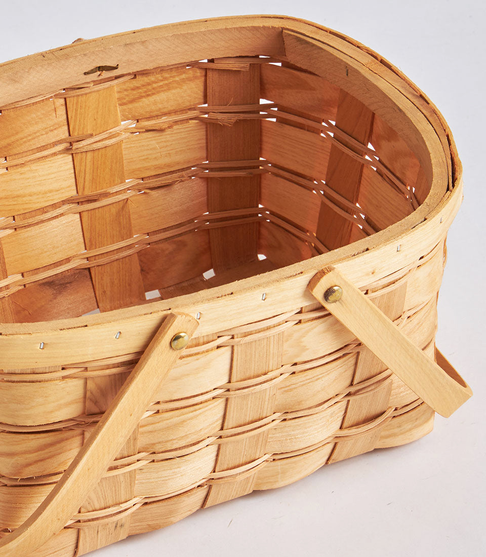 Handwoven light natural wood oval wicker basket with brass double side handles