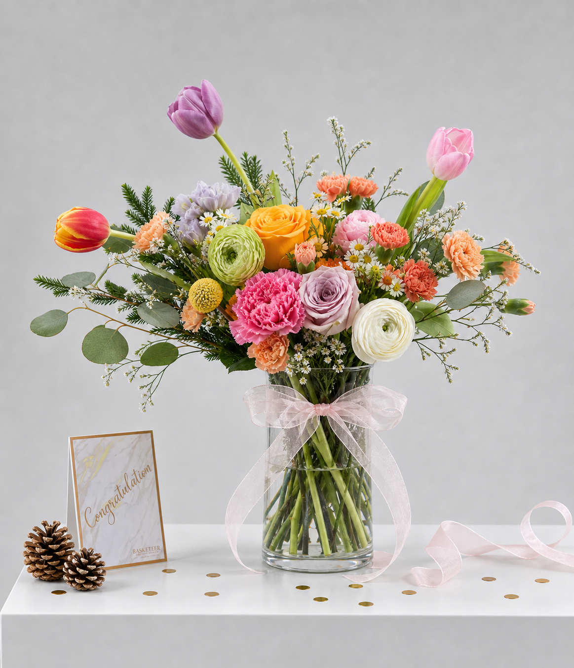 A vibrant Flowers by Basketeer arrangement featuring purple, pink, and orange tulips