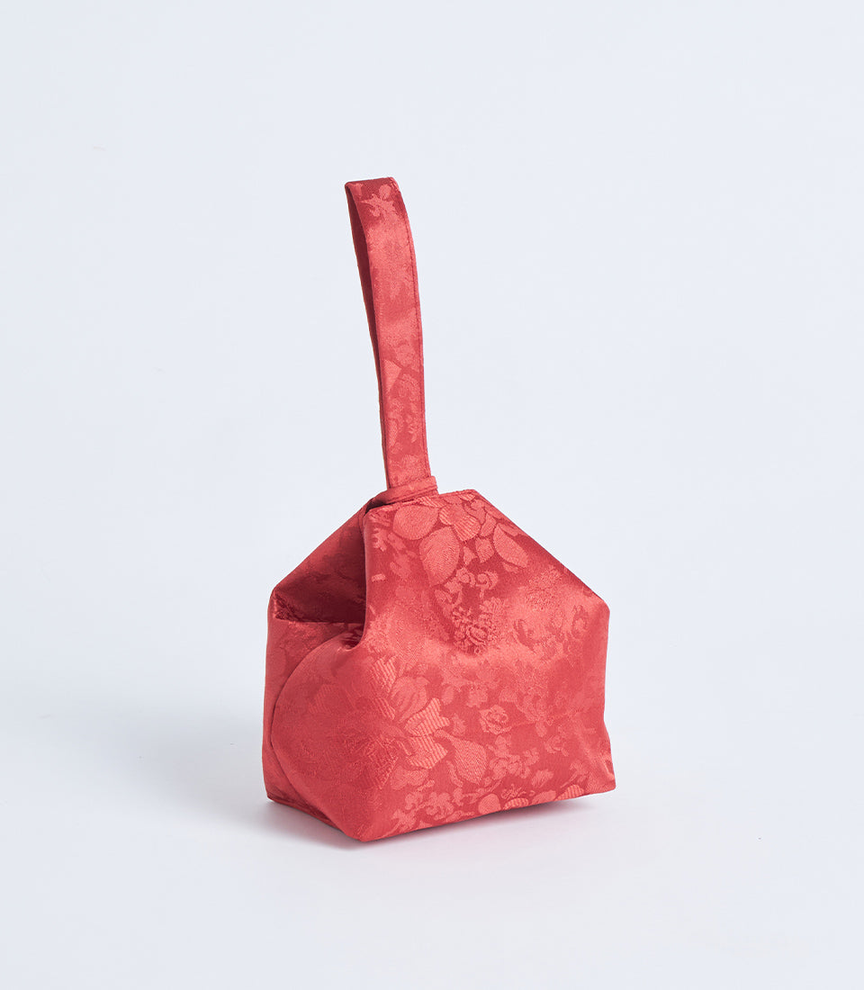 Red brocade fabric gift basket with floral jacquard weave and handle