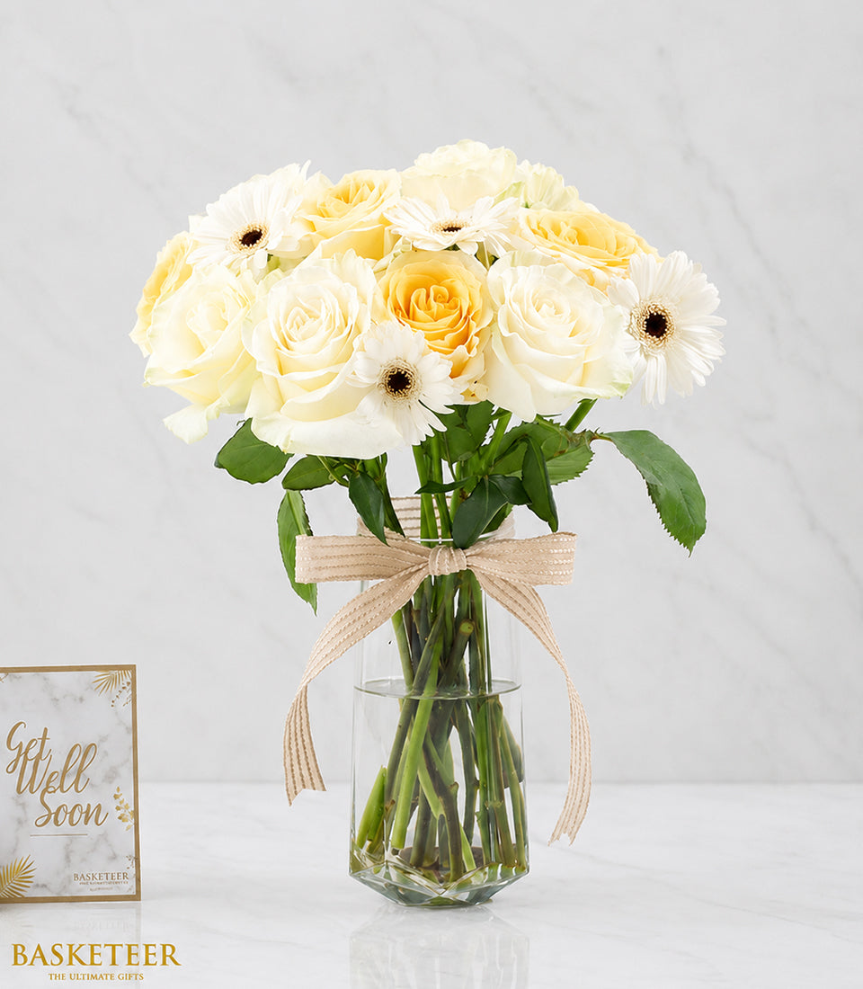 Elegant white and yellow rose bouquet with fresh white gerbera daisies, beautifully arranged in