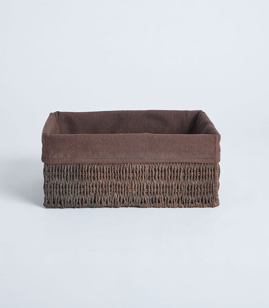 Handwoven rectangular wicker basket with dark brown fabric lining and tightly woven texture