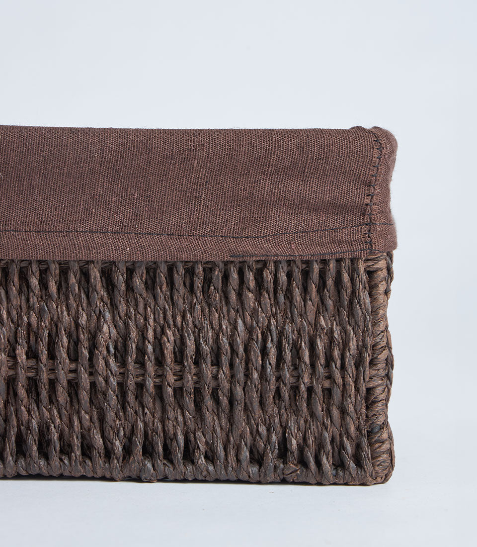 Handwoven rectangular wicker storage basket with natural brown exterior and fabric lining