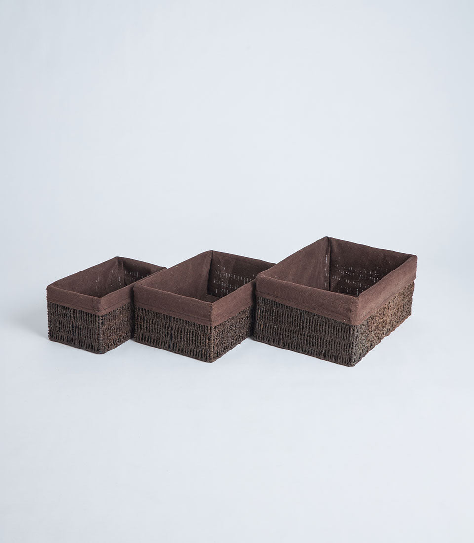 Handwoven rectangular wicker baskets in graduated sizes with fabric lining