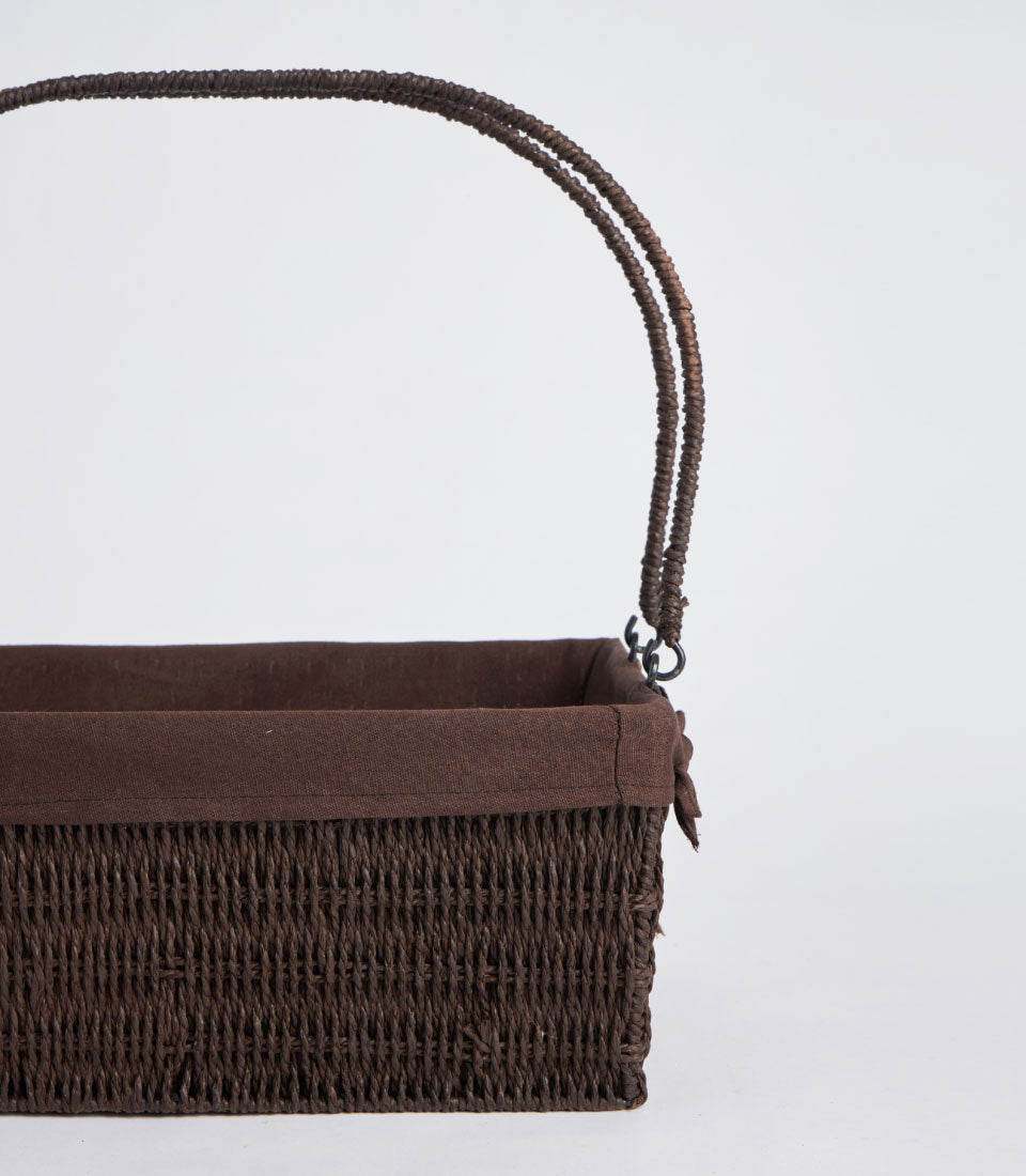 Dark brown handwoven wicker basket with fabric lining and double twisted handles