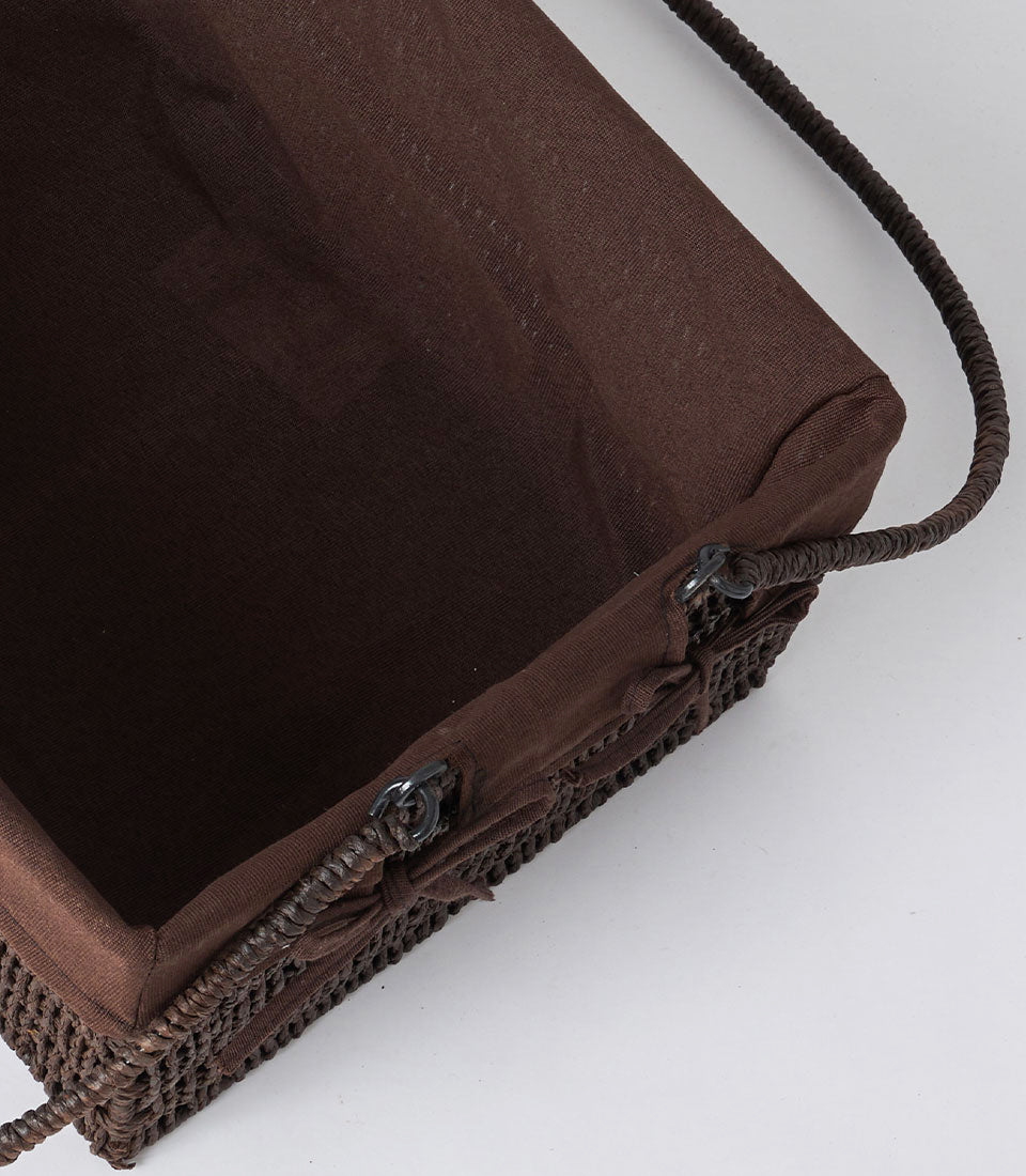 Dark brown handwoven rattan basket with double braided handles and fabric lining, perfect for luxury gift hampers