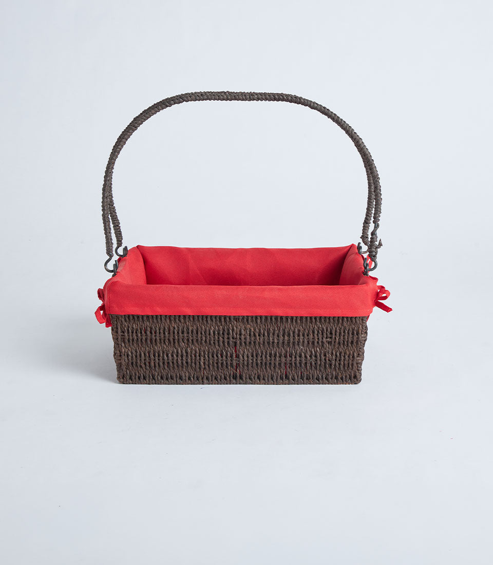 Dark brown handwoven wicker basket with red fabric liner and braided handle for premium gift presentation