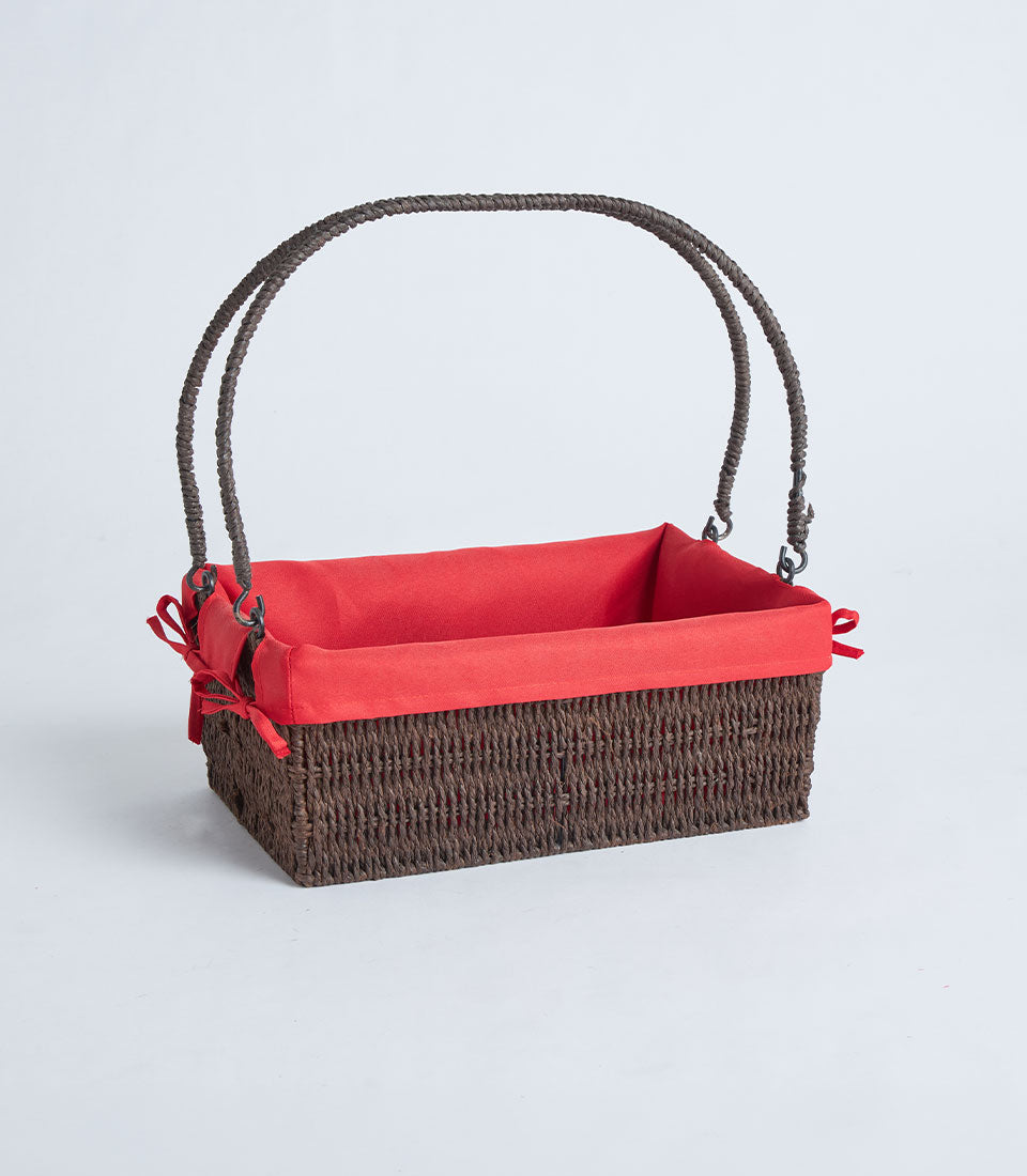 Handwoven rectangular wicker basket with red fabric liner and braided handles