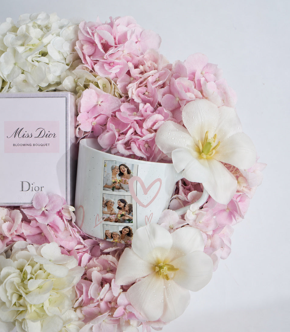 # Alt Text

Miss Dior Blooming Bouquet fragrance gift set surrounded by pink and white peonies with personalized photo mug.