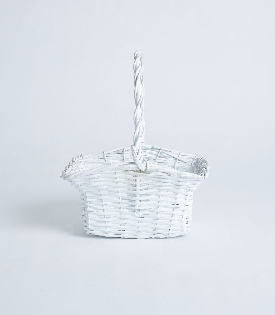 White wicker flared basket with twisted handle, ideal for luxury gift hampers and artisan presentations