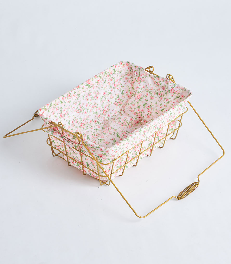 Gold wire rectangular basket with pink floral fabric lining and dual handles