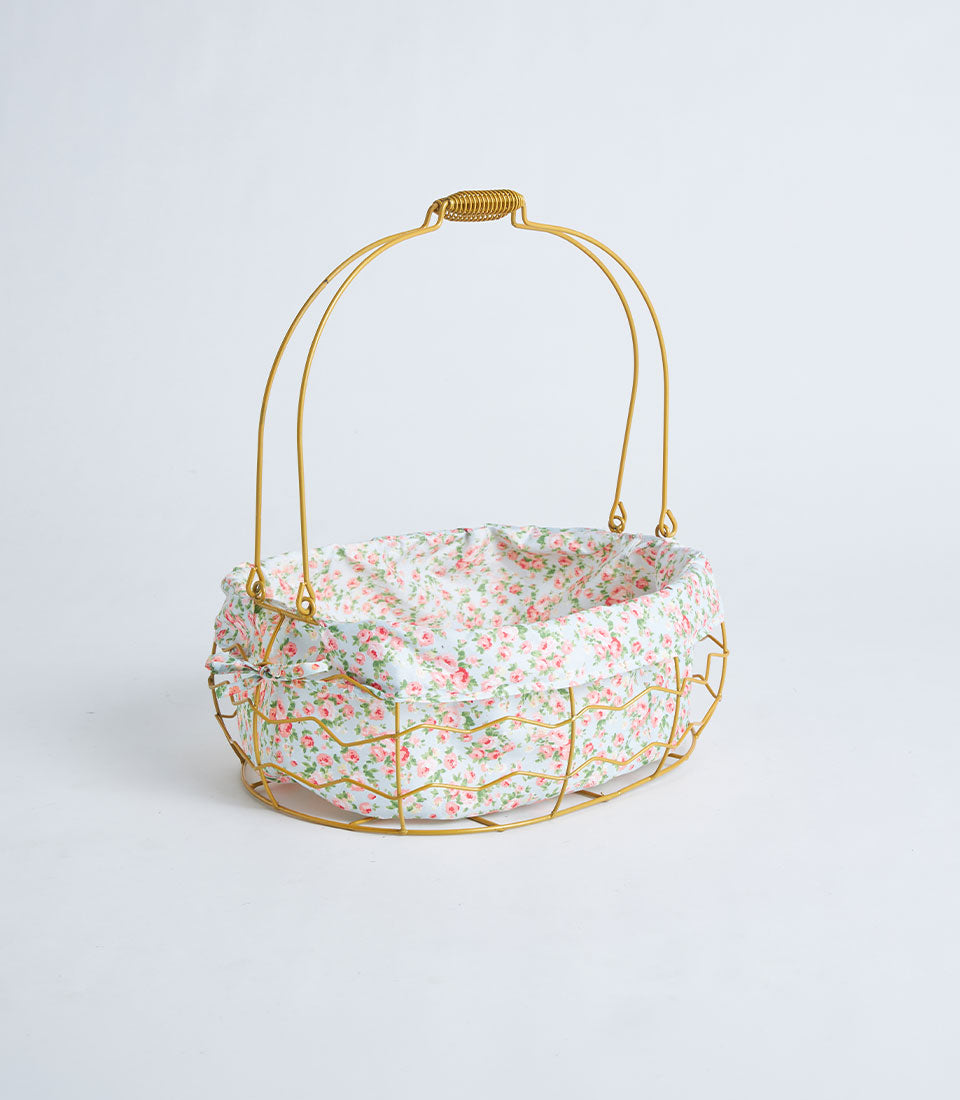 Gold oval wire basket with floral fabric lining and handle for premium gift presentation