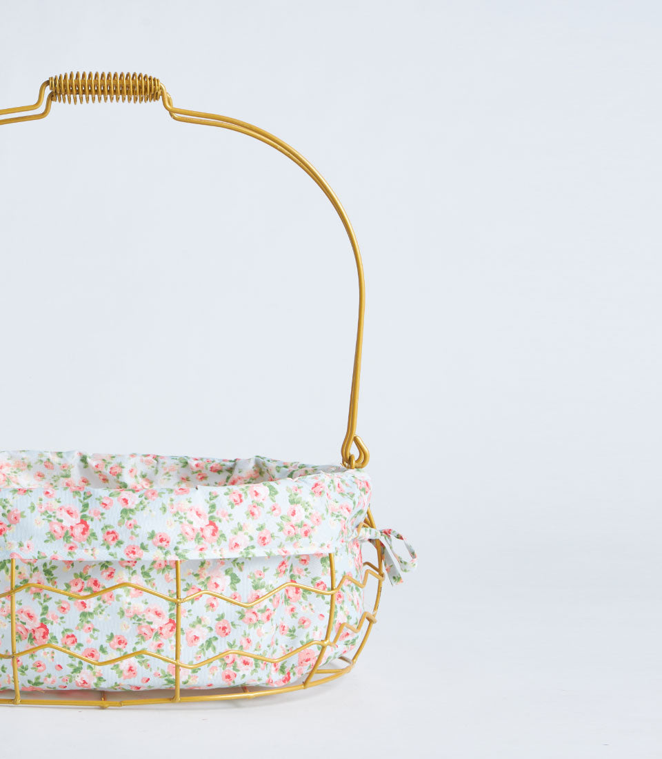 Gold wire oval basket with floral fabric lining and arched handle for gifts