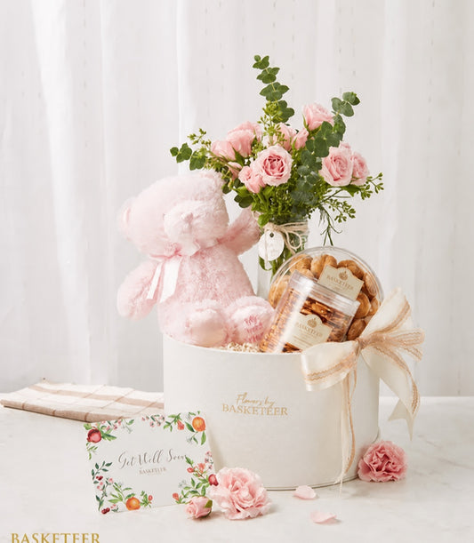 Basketeer's premium hamper featuring a charming pink teddy bear, fresh