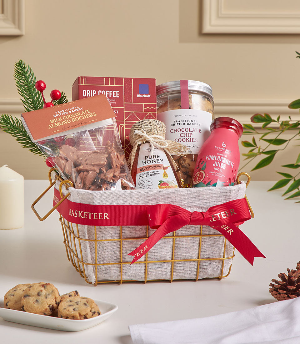 Premium mini gift basket with drip coffee, chocolate cookies, roasted almonds, and honey in gold wire frame with red ribbon