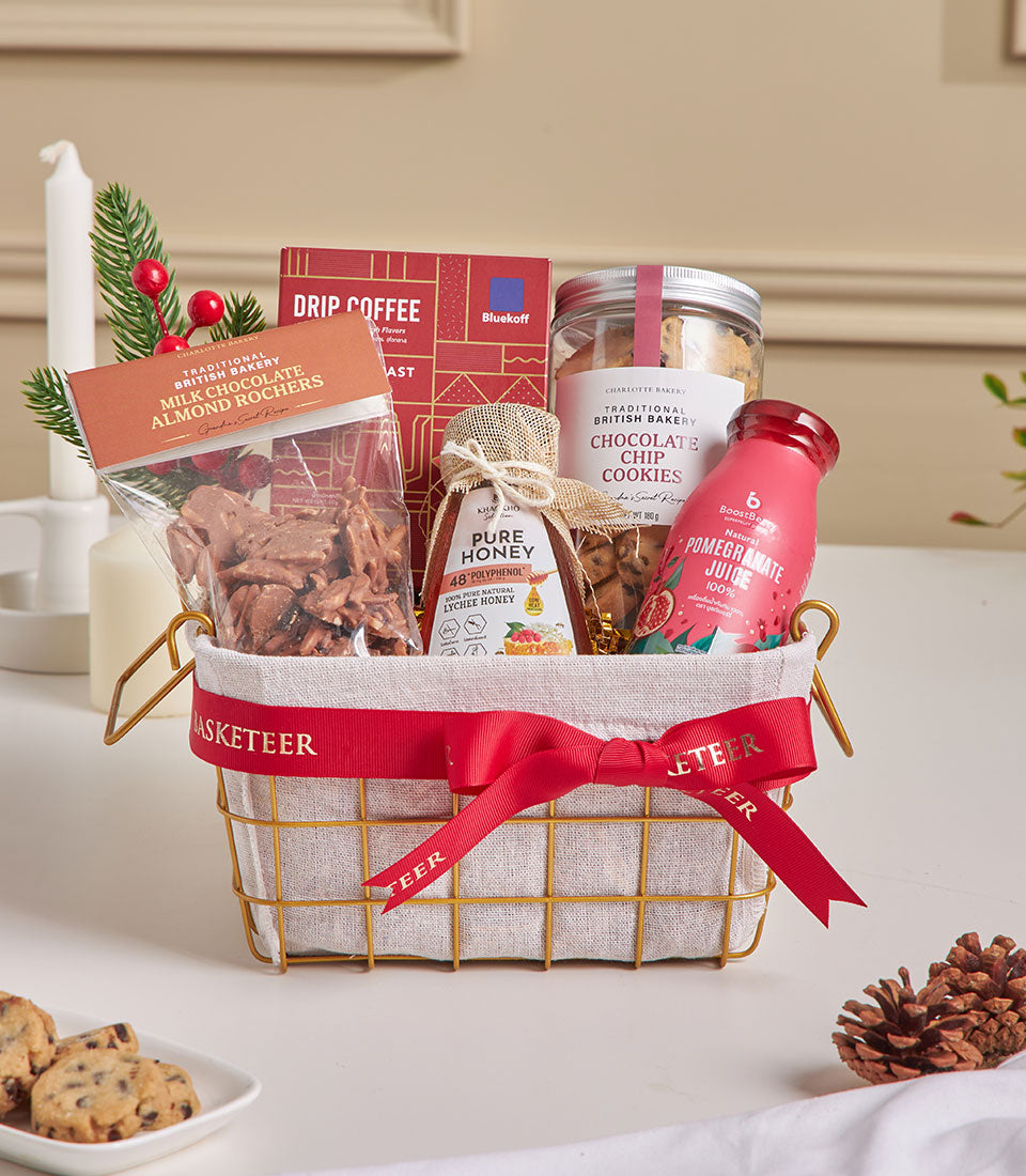 Premium mini gift basket with coffee, honey, cookies and chocolate rochers, tied with red ribbon for New Year gifting