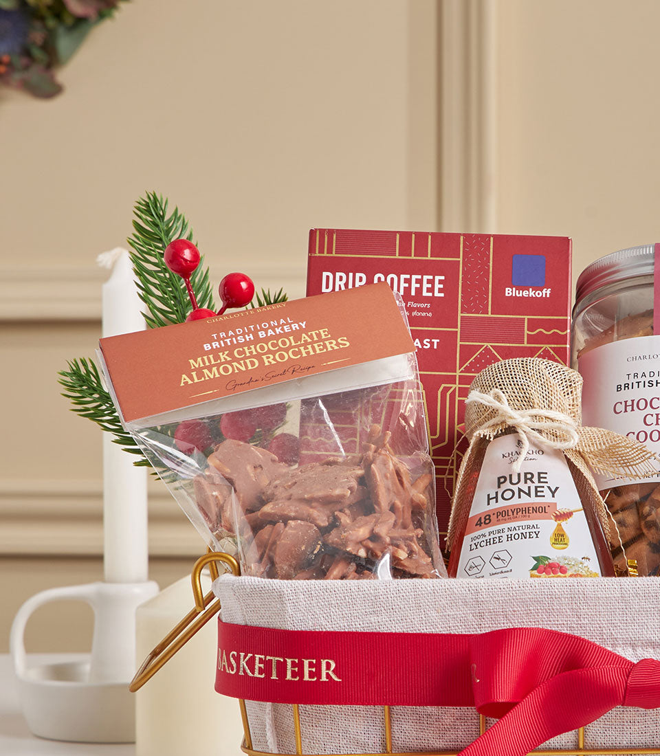 Premium gift basket with coffee, cookies, honey, and festive accents in gold wire frame with red ribbon
