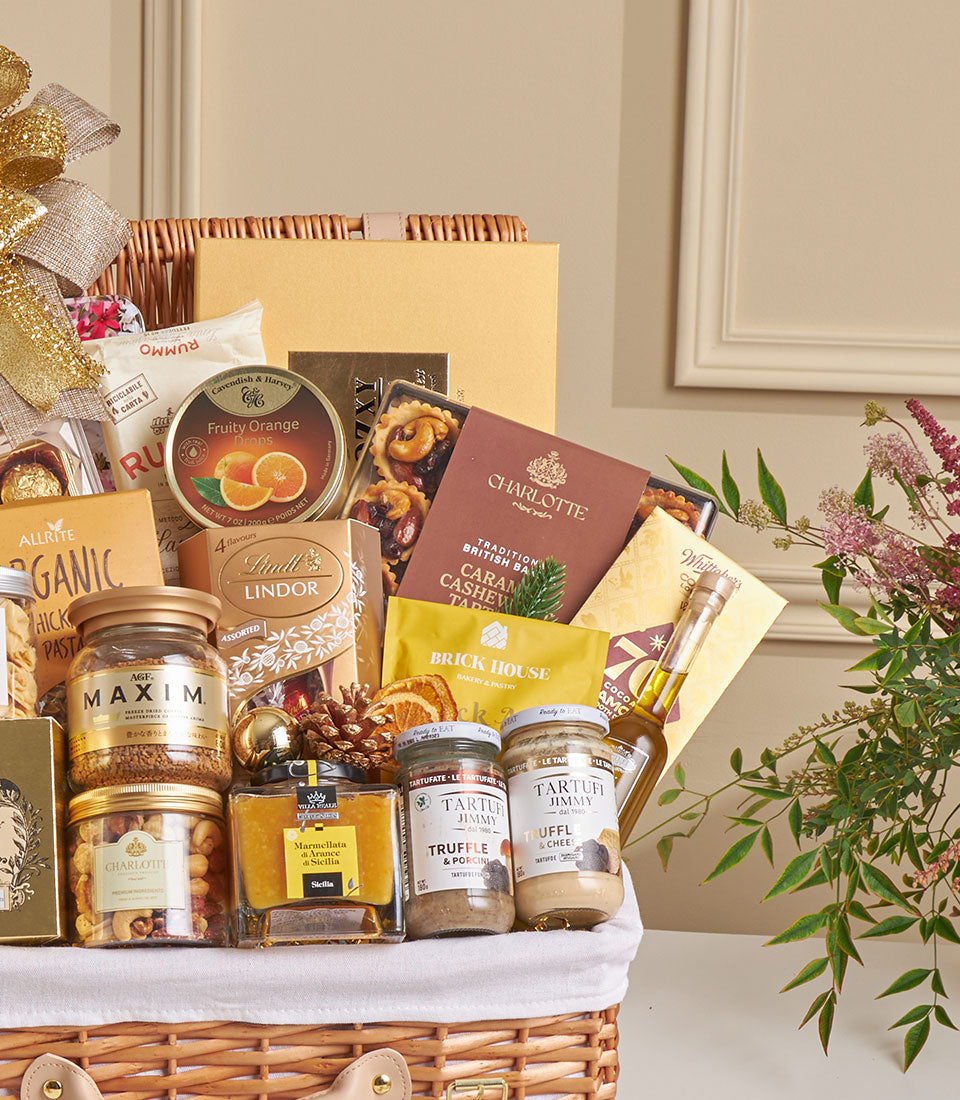 Luxury New Year hamper with truffles, Lindt chocolates, gourmet jars, olive oil, and festive gold accents in wicker basket