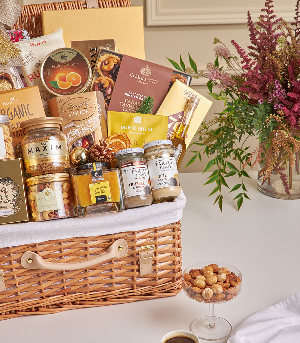 Premium wicker hamper filled with gourmet truffles, chocolates, coffee, and fine foods for New Year gifting