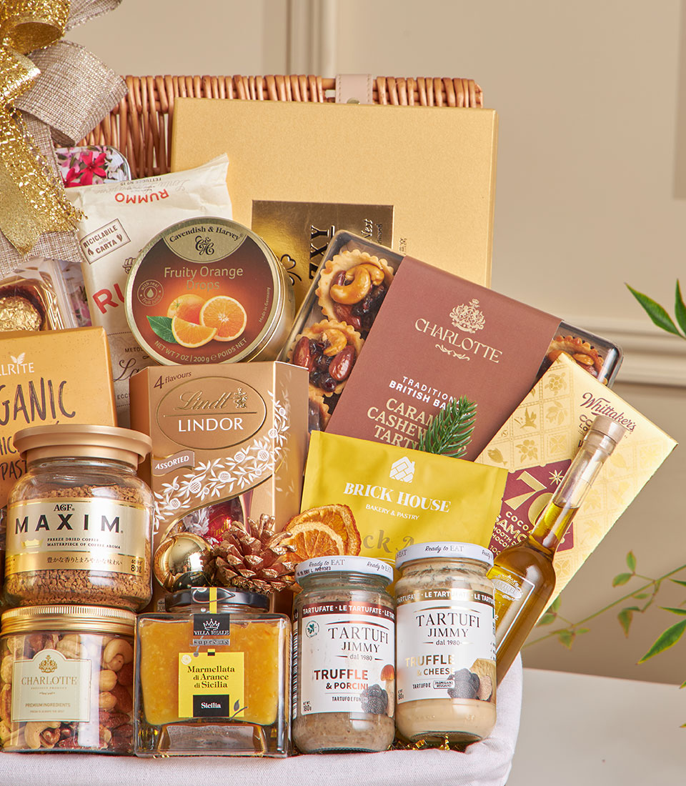 Luxury wicker hamper with gourmet truffles, chocolates, nuts, and fine foods, gold ribbon bow, New Year gift basket