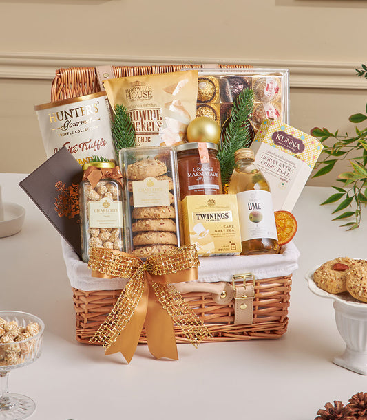 Luxury gourmet gift hamper with truffle chips, artisan chocolates, and premium treats in woven wicker basket with gold