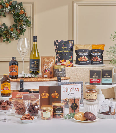 Luxury wicker picnic hamper with chocolate, gourmet nuts, tea, and premium beverages for New Year celebrations