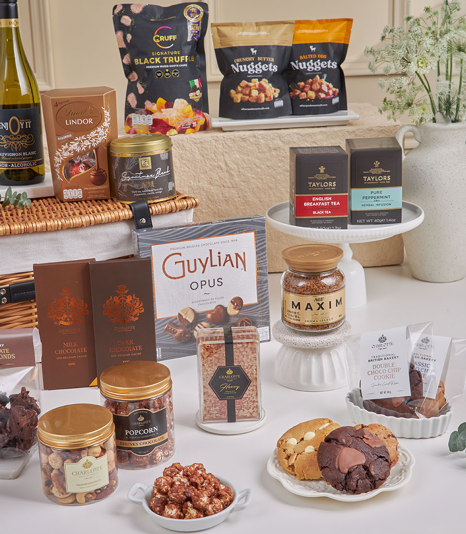 Basketeer premium hamper: A wicker basket overflowing with chocolates, gourmet popcorn, truffle snacks, and fine teas. The perfect luxury gift basket Bangkok.