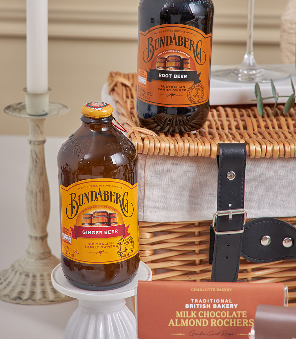 Luxury chocolate and tea New Year hamper with Bundaberg beverages in wicker basket, Charlotte Bakery chocolate, and
