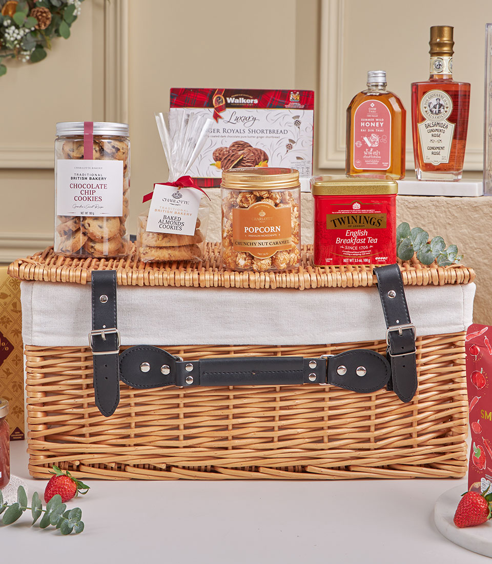 Basketeer luxury gift basket: shortbread, cookies, popcorn, tea, honey, and jam arranged in a wicker hamper. Perfect premium corporate gift for Bangkok delivery.