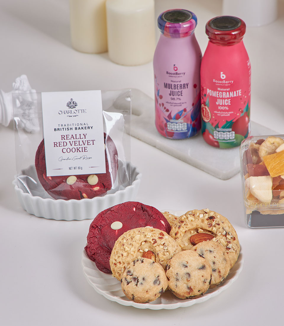 Prosperity New Year Gourmet Table with red velvet cookies, almond biscuits, mulberry and pomegranate juice, dried fruit