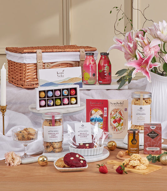 Luxury pink guava and chocolate tea gift hamper with wicker basket, gourmet cookies, artisan chocolates, and fresh florals