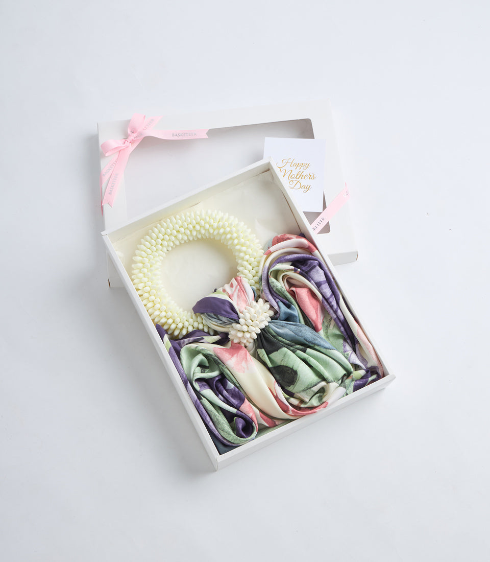 Elegant Mother's Day gift set in white box with cream pearl beaded wreath, colorful silk scarves in purple, pink and green, small white flowers, and pink ribbon.