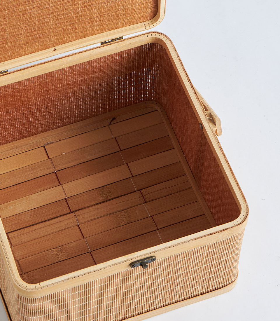 Natural bamboo storage basket with woven interior lining and metal clasp, ideal for luxury gift hampers and artisan storage