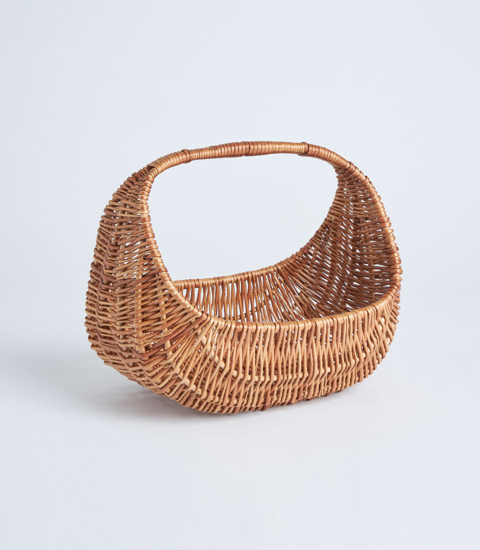 Handwoven light brown wicker basket with oval handle, artisan crafted for premium gift hampers