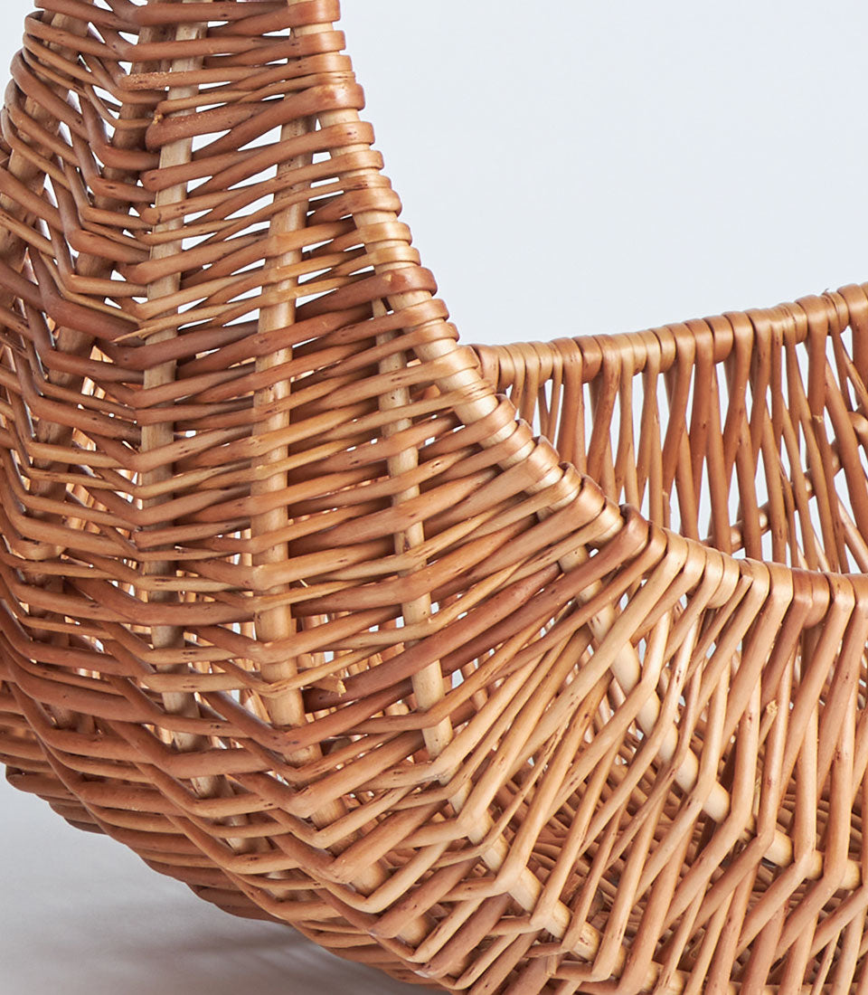 Handwoven natural wicker basket with oval handles, light brown rattan craftsmanship