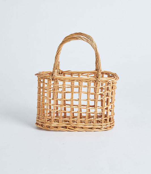 Light brown handwoven wicker basket with arched handle and open weave grid pattern