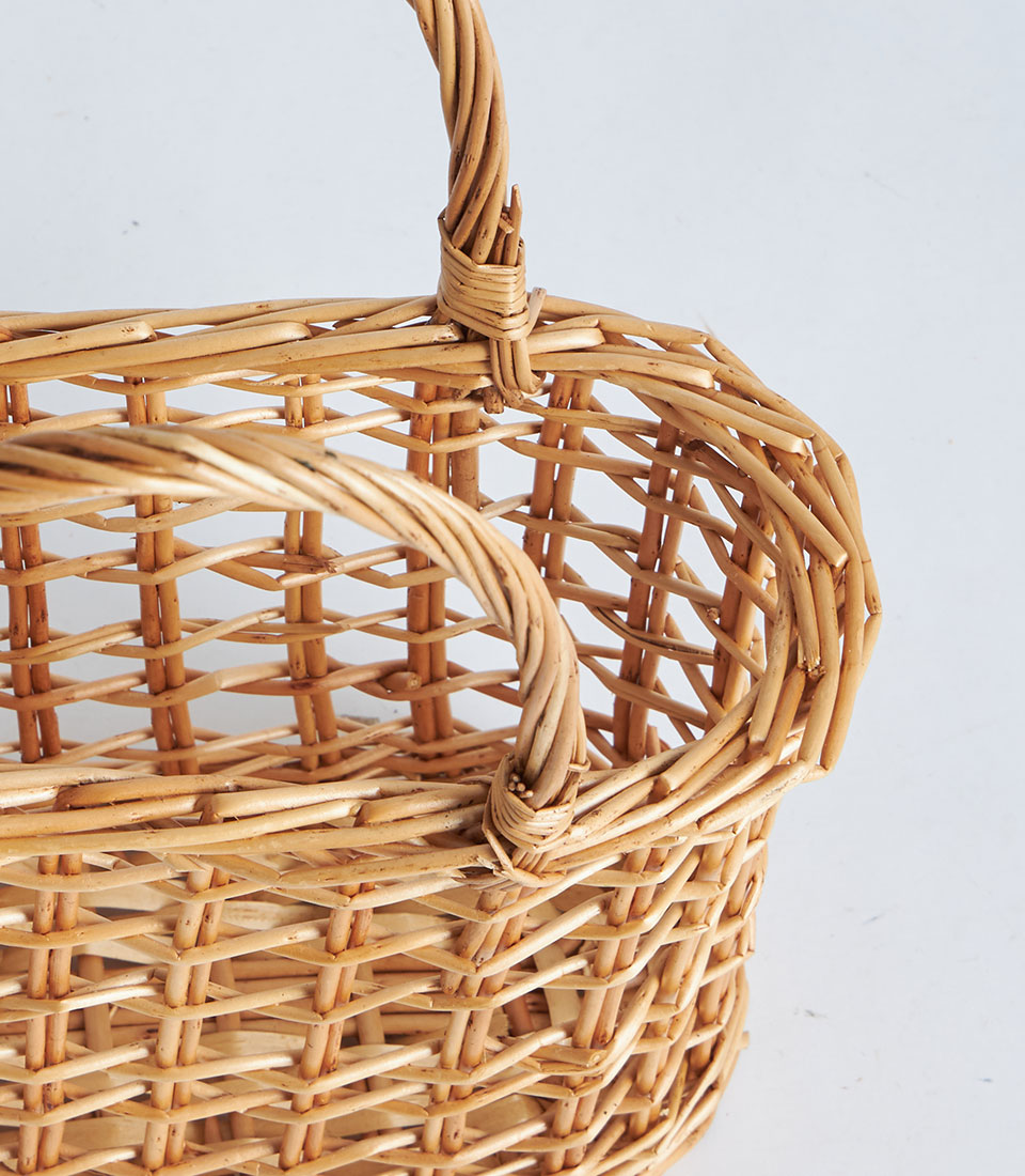 Natural wicker gift basket with dual handles, handwoven light brown open-weave design