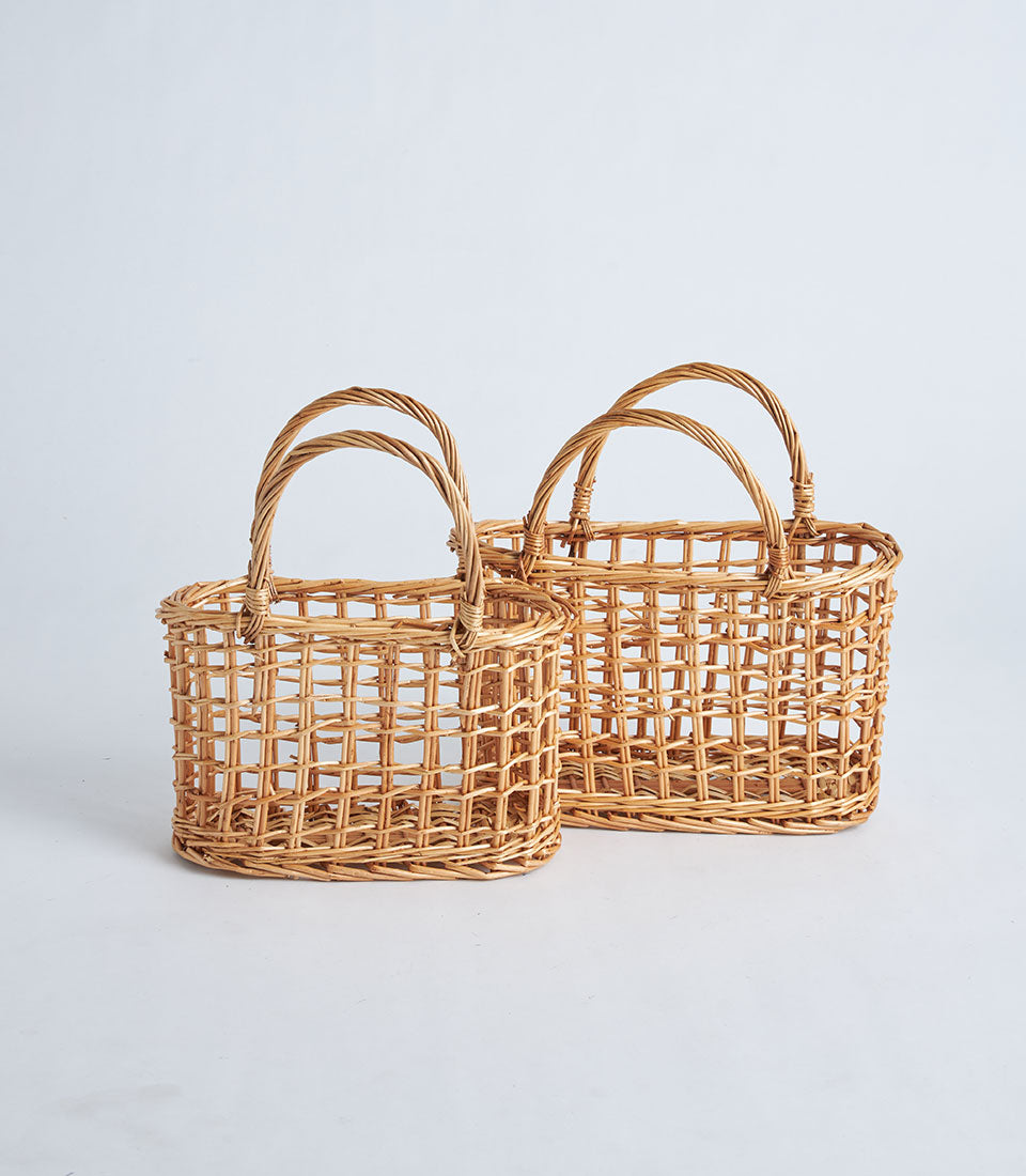 Light brown open-weave wicker baskets with twisted handles, handcrafted for premium gift presentation