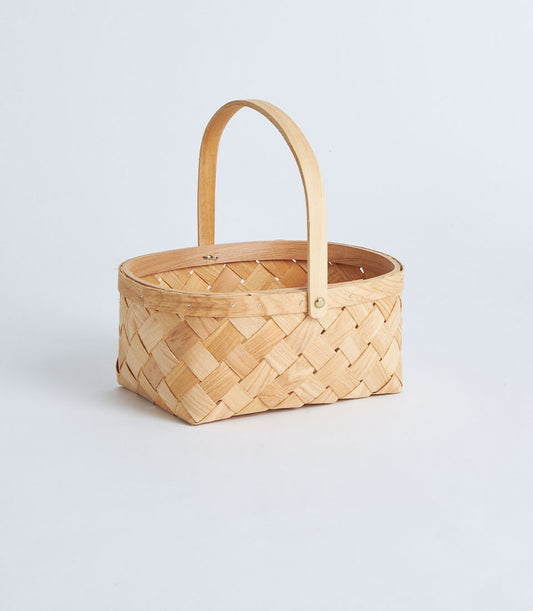 Light natural bamboo oval basket with wooden handle, woven with diagonal strips and reinforced rim
