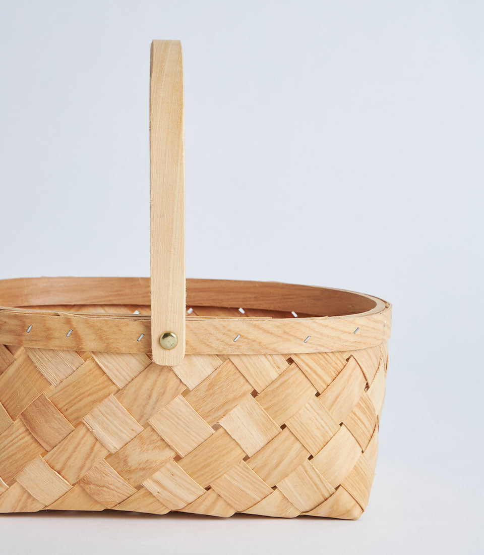 Light natural bamboo oval basket with wooden handle, artisan woven construction for premium gift hampers