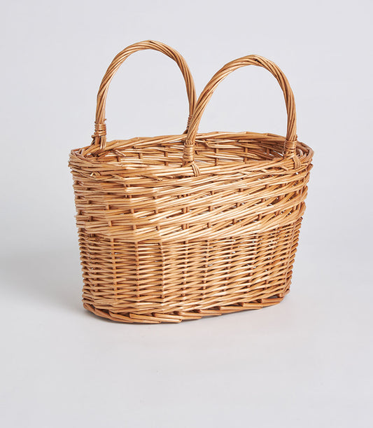 Handwoven light brown oval wicker basket with double arched handles, natural willow craft